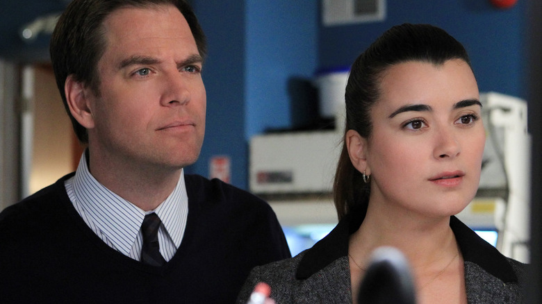 Cote de Pablo and Michael Weatherly looking at screen