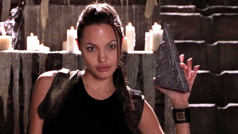 Lara Croft holding artifact