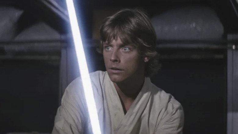 Luke Skywalker holding a lightsaber