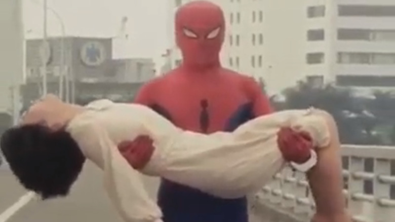 Spider-Man holding woman